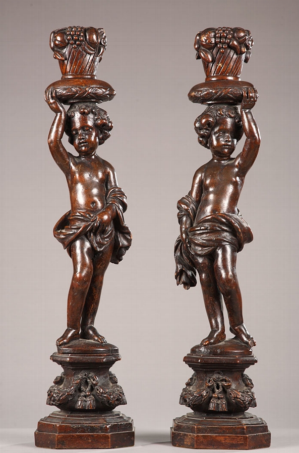 Pair of walnut sculpted figures of putti