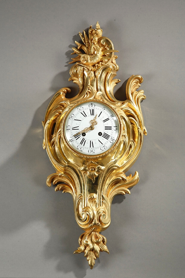 Wall cartle clock in gilded bronze and Louis XV style ornate with a dolphin