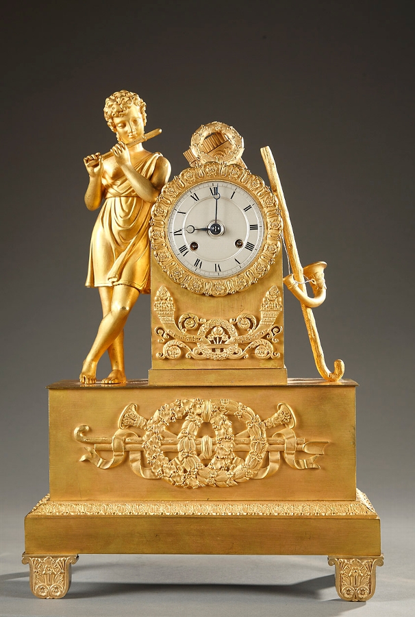 Early 19th century French mantle clock with a cupid playing flute