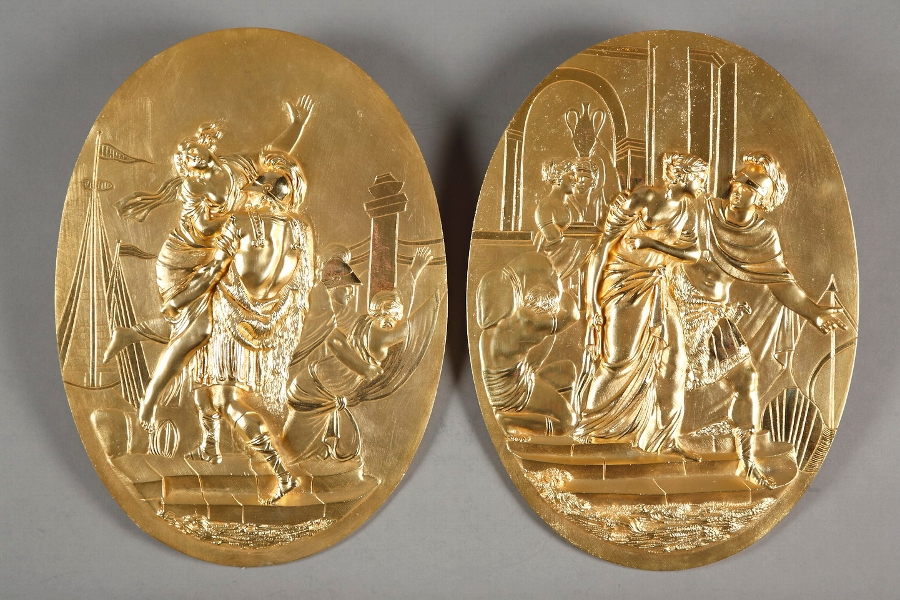 Two gilded bronze medallions representing the rape of Helen and abduction of Cassandra