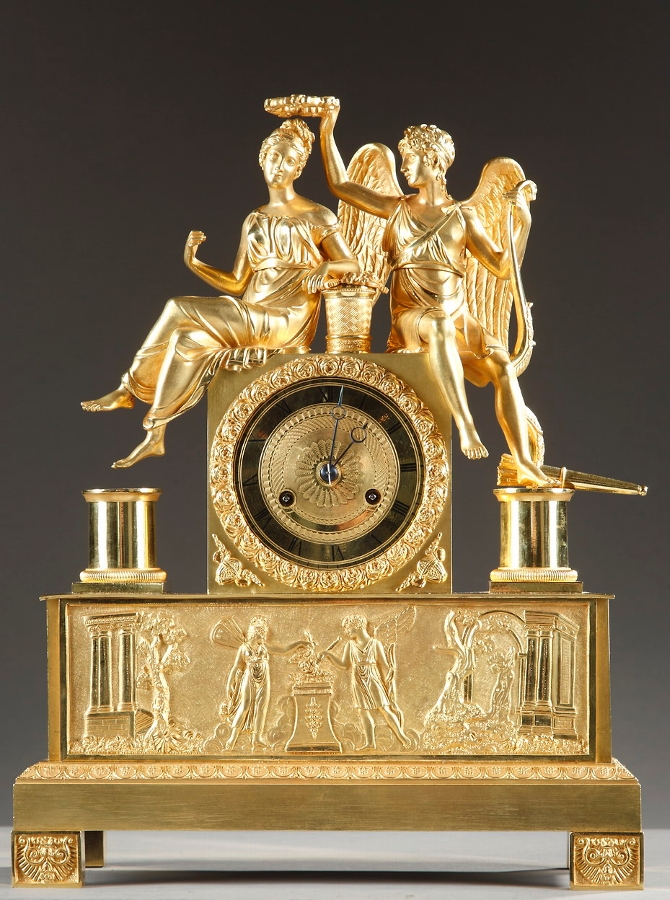 Early 19th century gilt bronze mantel clock with Cupid and Psyche: the crowning