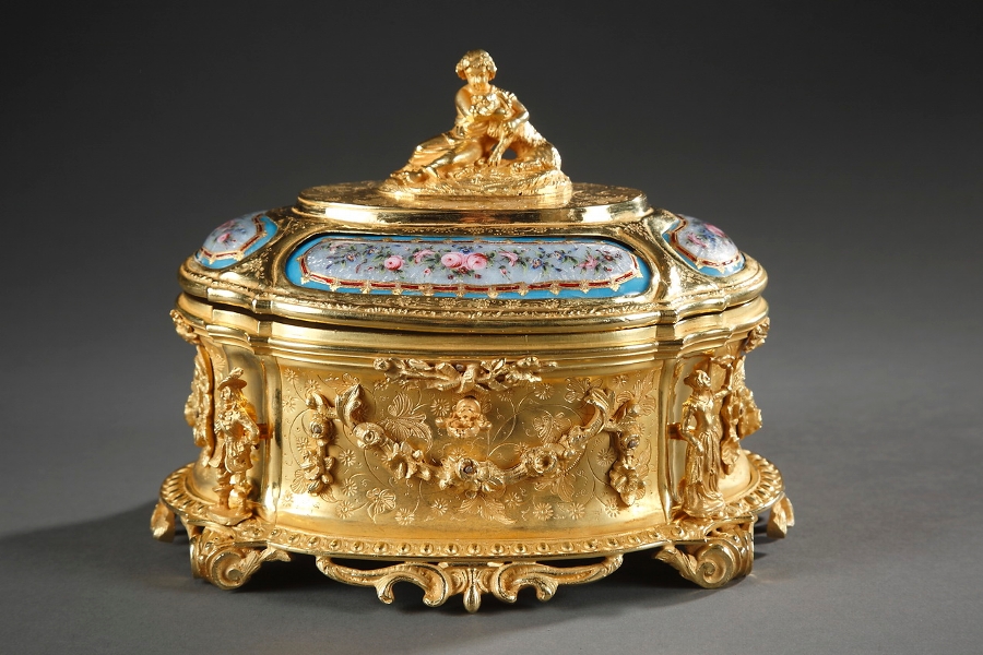 A gilded and chiseled jewel box with enameled plaques signed TAHAN