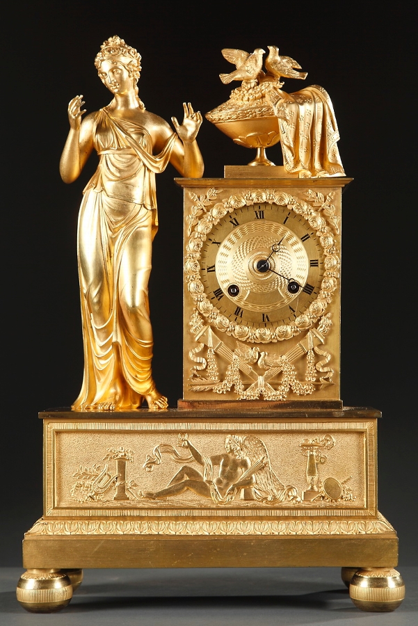 A Charles X gilt bronze mantel clock with woman and two doves