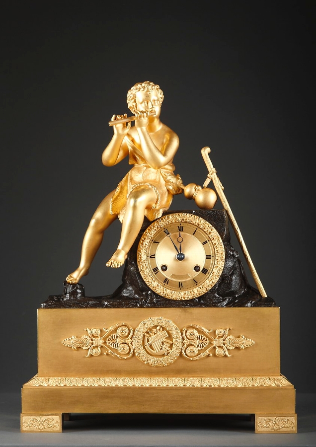 Gilded and patinated bronze mantel clock with a shepherd playing the flute by Otran Fils