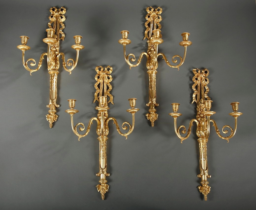 A 19th century set of 4 gilt bronze three lights wall sconces with ribbon decoration