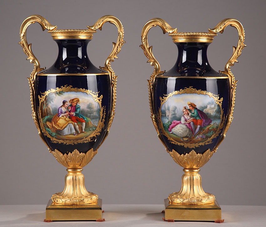 Pair of gilt and polychrome 19th century Paris porcelain vases with bucolic sc?nes and flowers