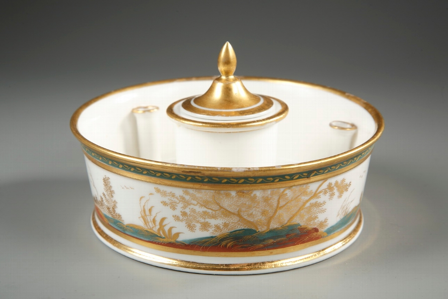 Early Nineteenth century porcelain inkwell decorated with figures in a landscape