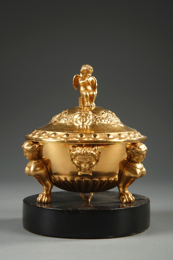 A late 19th century tidy in gilded bronze and black marble
