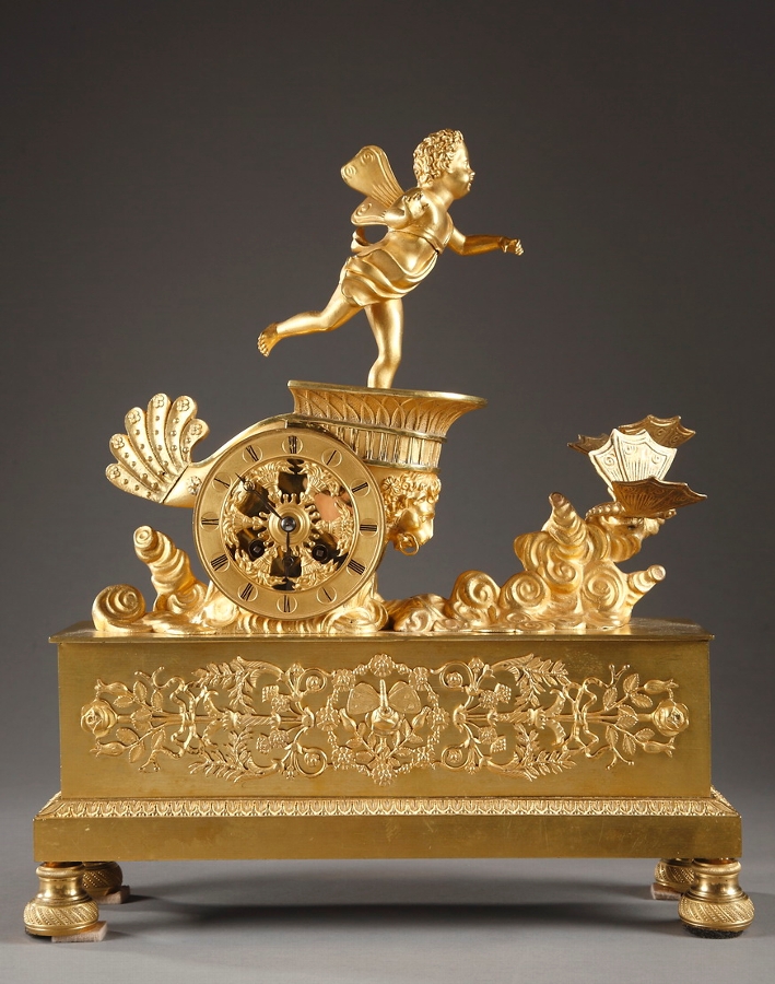 French Restauration gilt bronze mantel clock with putto in a chariot pulled by butterflies