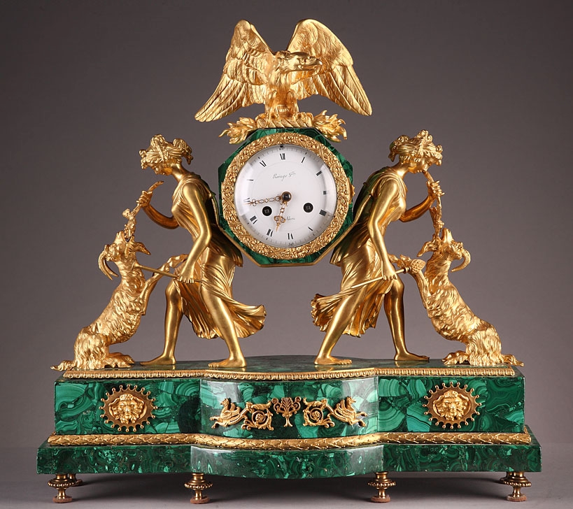 A gilt bronze and malachite figural mantel clock signed RAINGO