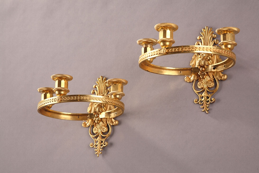 An early 19th century pair of gilt bronze sconces