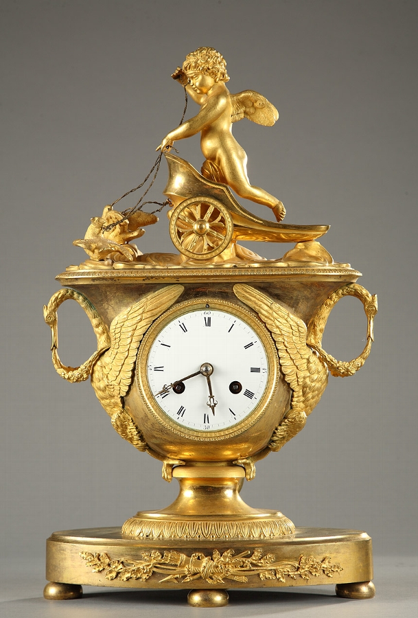 Empire mantel clock with putto in a chariot