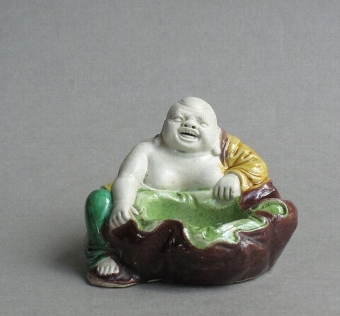 Famille verte biscuit decorated brushwasher figure of Budai C18th/C19th