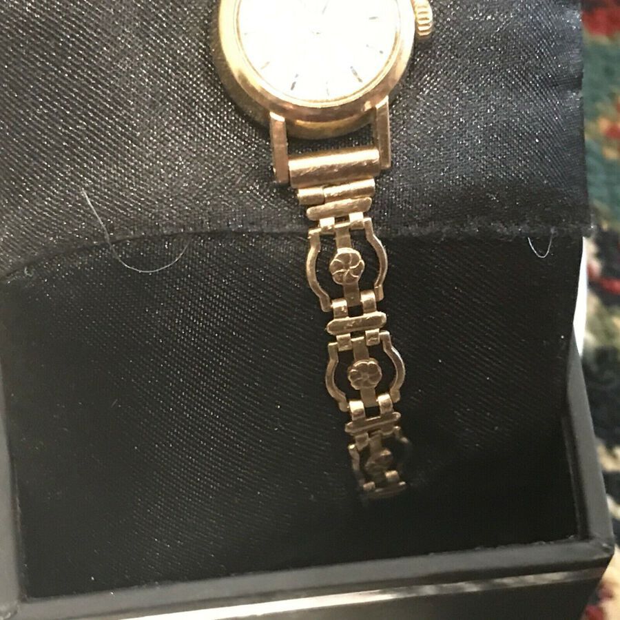 Antique Omega Ladymatic 9 CT gold wristwatch and bracelet.