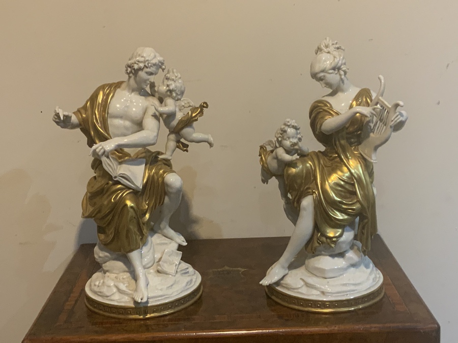 Pair of neoclassical figures with cherubs before restoration