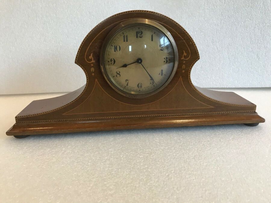 Antique Art nouveau mahogany mantle clock with inlaid decoration.