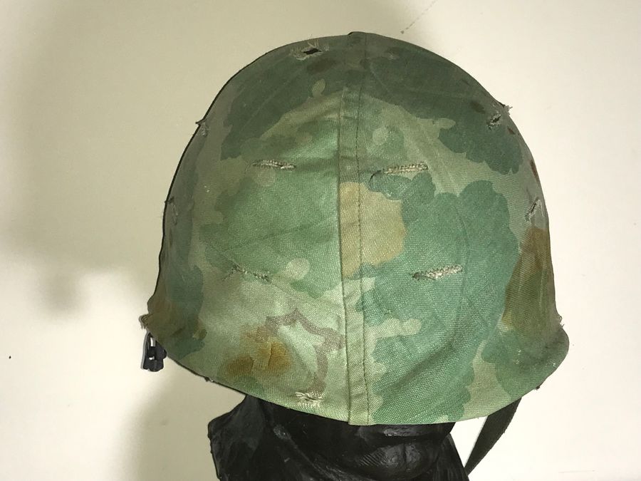 Antique Vietnam American soldiers helmet liner and camouflage cover 