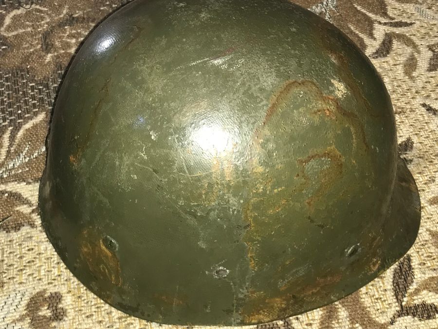 Antique Vietnam American soldiers helmet liner and camouflage cover 