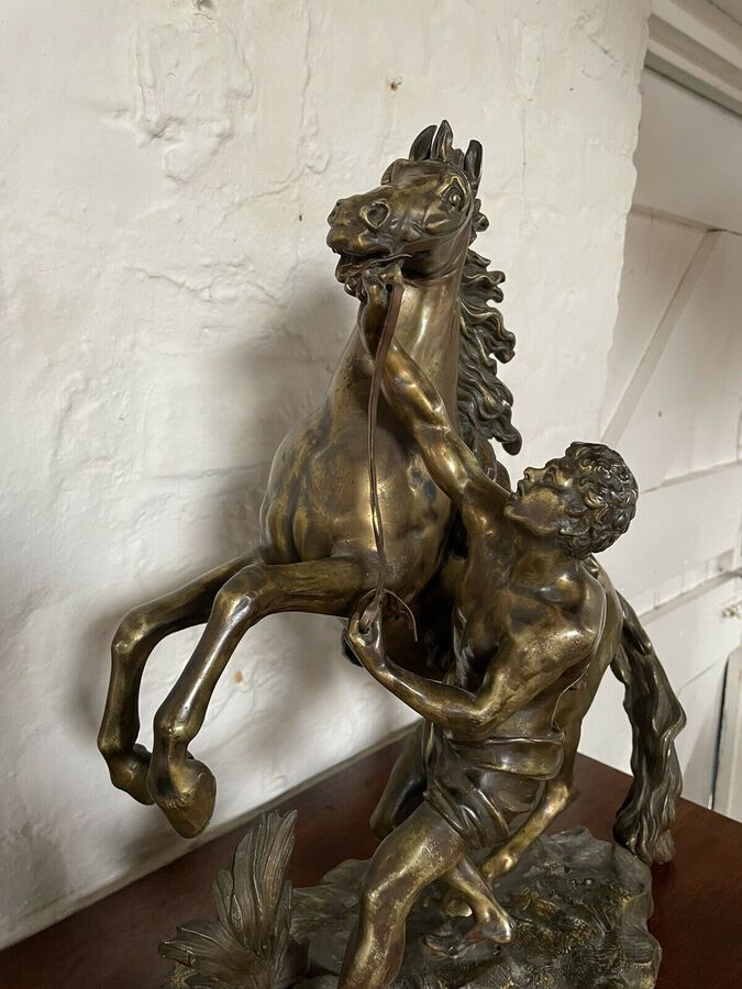 Antique A FINE PAIR OF GILT-BRONZE MODELS OF THE MARLEY HORSES.