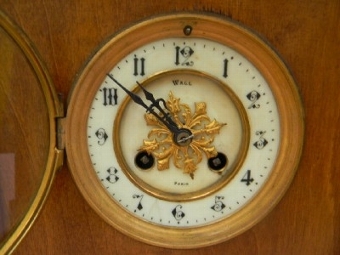 Antique Mantle clock mahogany cased movement mechanical 8 day strikes the hours.