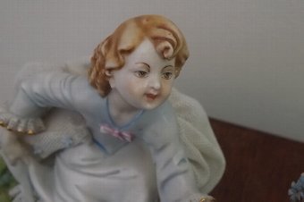 Antique porcelain girl & boy on seesaw European work 