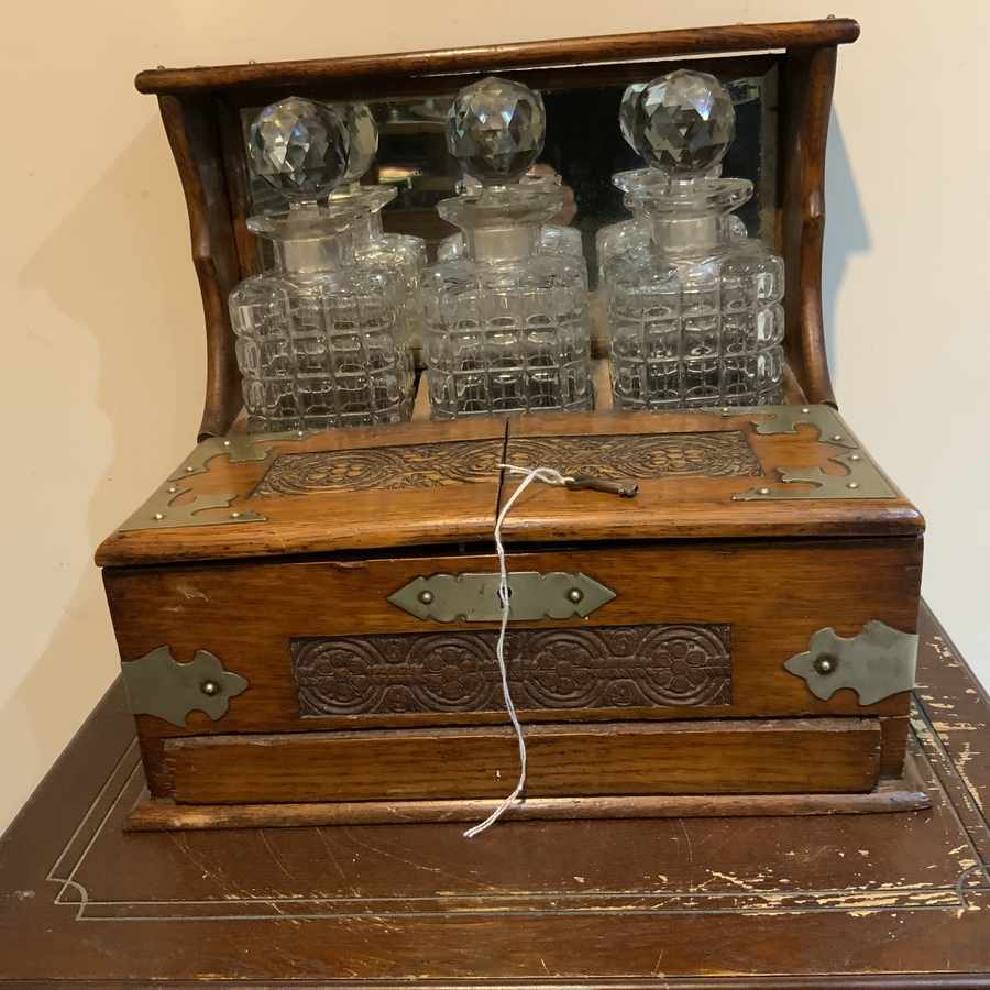 Antique Tantalus three decanter’s in oak case