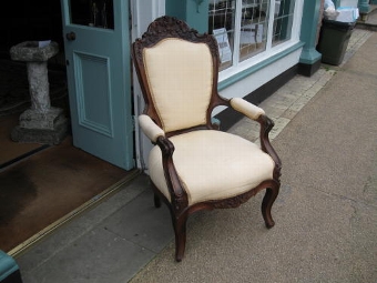 A 19TH CENTURY ROSEWOOD CARVED ARMCHAIR