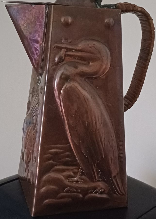 Antique A Newlyn copper Cormorant and John Dory decorated hot water jug, dating circa 1905