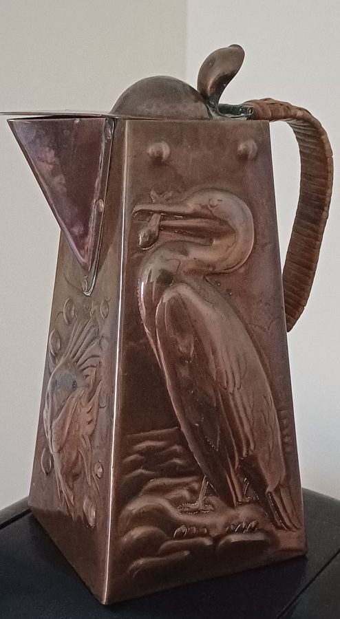 Antique A Newlyn copper Cormorant and John Dory decorated hot water jug, dating circa 1905