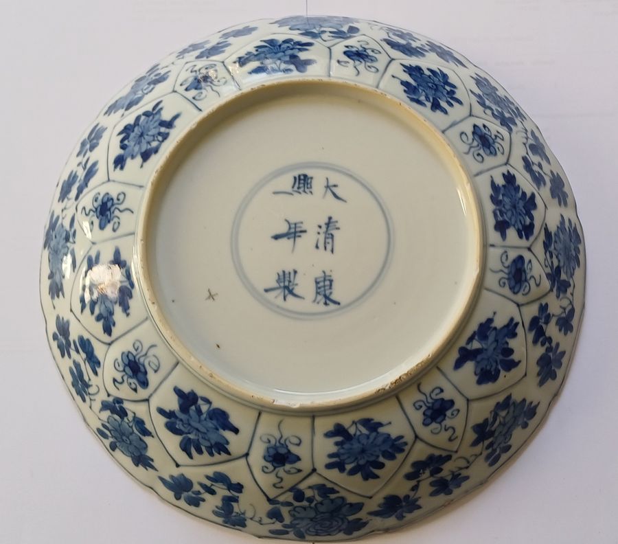 Antique Chinese blue and white moulded floral dish with barbed rim, the reverse with the Kangxi six-character mark and of the period