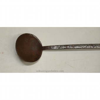 Antique Iron ladle with geometric designs on the handle