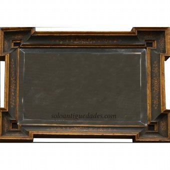 Wall mirror with lugs at the corners of the frame