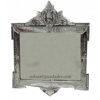 Venetian wall mirror and carved crest crowned