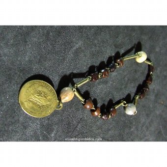 Strung seed bracelet with metal links