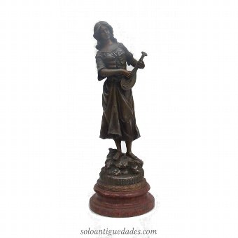 Female sculpture playing an instrument