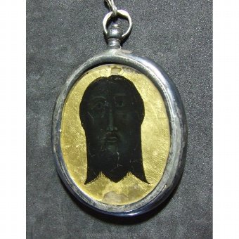 Antique Medallion. Image Franciscan friar writing
