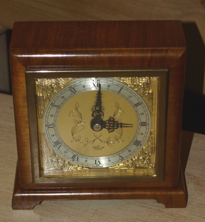 Elliot mantle clock in a walnut case.