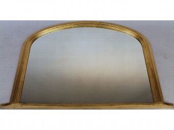 A Victorian style gilt wood over mantel mirror, with a shaped D-end outline