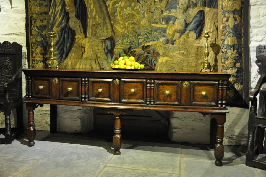 Antique A CHARLES II OAK MOULDED FRONTED LOW DRESSER OF UNUSUAL CONFIGURATION. ENGLISH CIRCA 1680