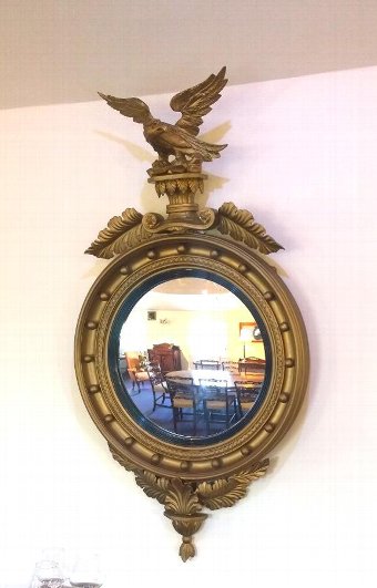 Round gilt mirror with impressive eagle mount