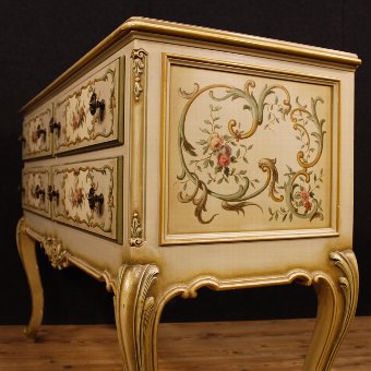 Antique Italian lacquered, golden and painted chest of drawers with floral decorations