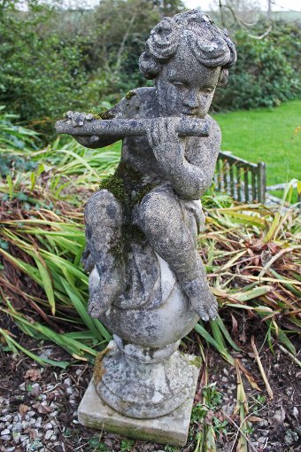 Antique Ornamental garden Statues. Four weathered classical figures of Putti on Ball Finials
