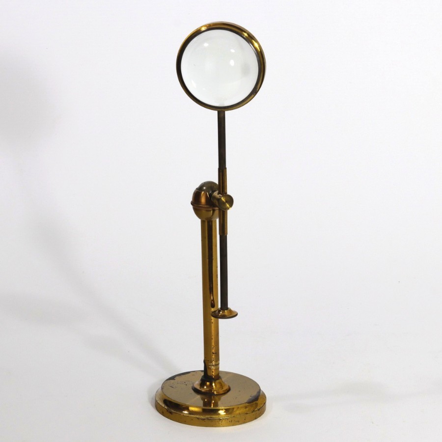 antique magnifying glass on stand
