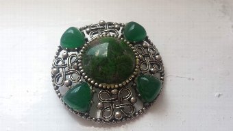 1900s celtic brooch featuring green stones