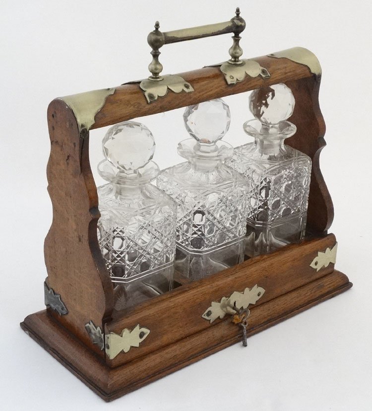 Tantalus : an oak and silver plate 3 glass decante