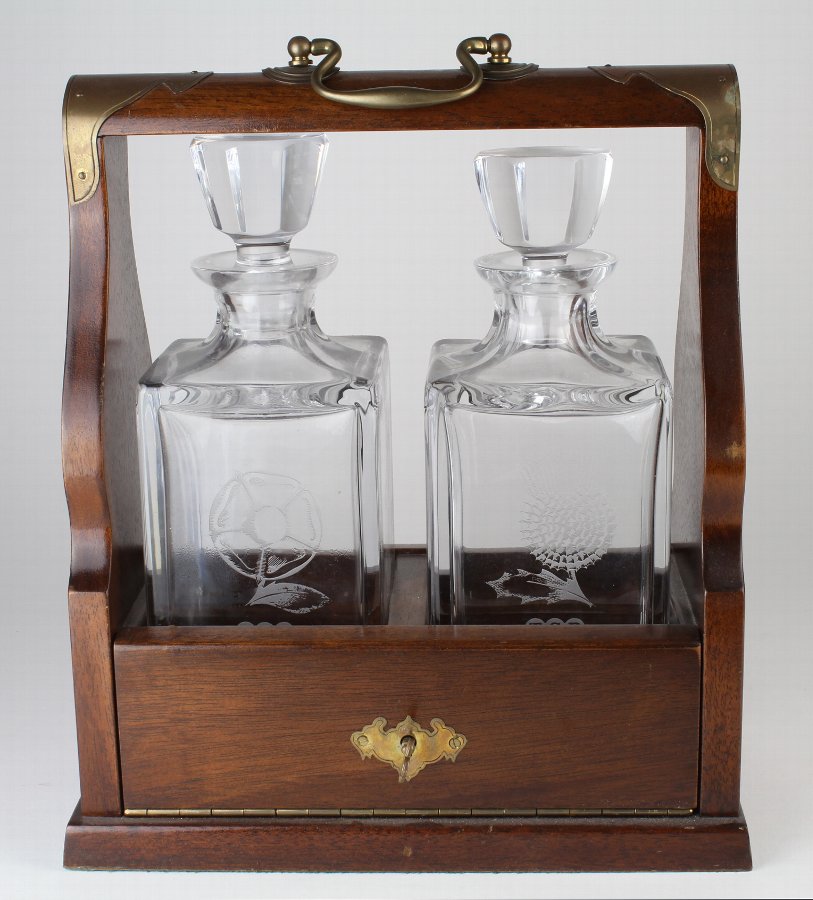 Oak two decanter tantalus with brass mounts & handle,