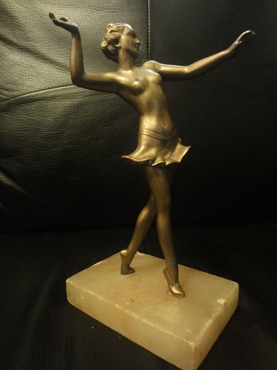 An Art deco figure of a dancing maiden on an onyx base, 20cm