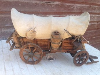 Antique  35cm long by 25cm high by 18cm width 20th century wooden model of a 19th century American wild-west canvas covered wagon 