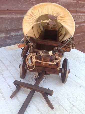 Antique  35cm long by 25cm high by 18cm width 20th century wooden model of a 19th century American wild-west canvas covered wagon 