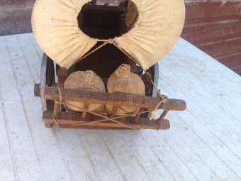 Antique  35cm long by 25cm high by 18cm width 20th century wooden model of a 19th century American wild-west canvas covered wagon 